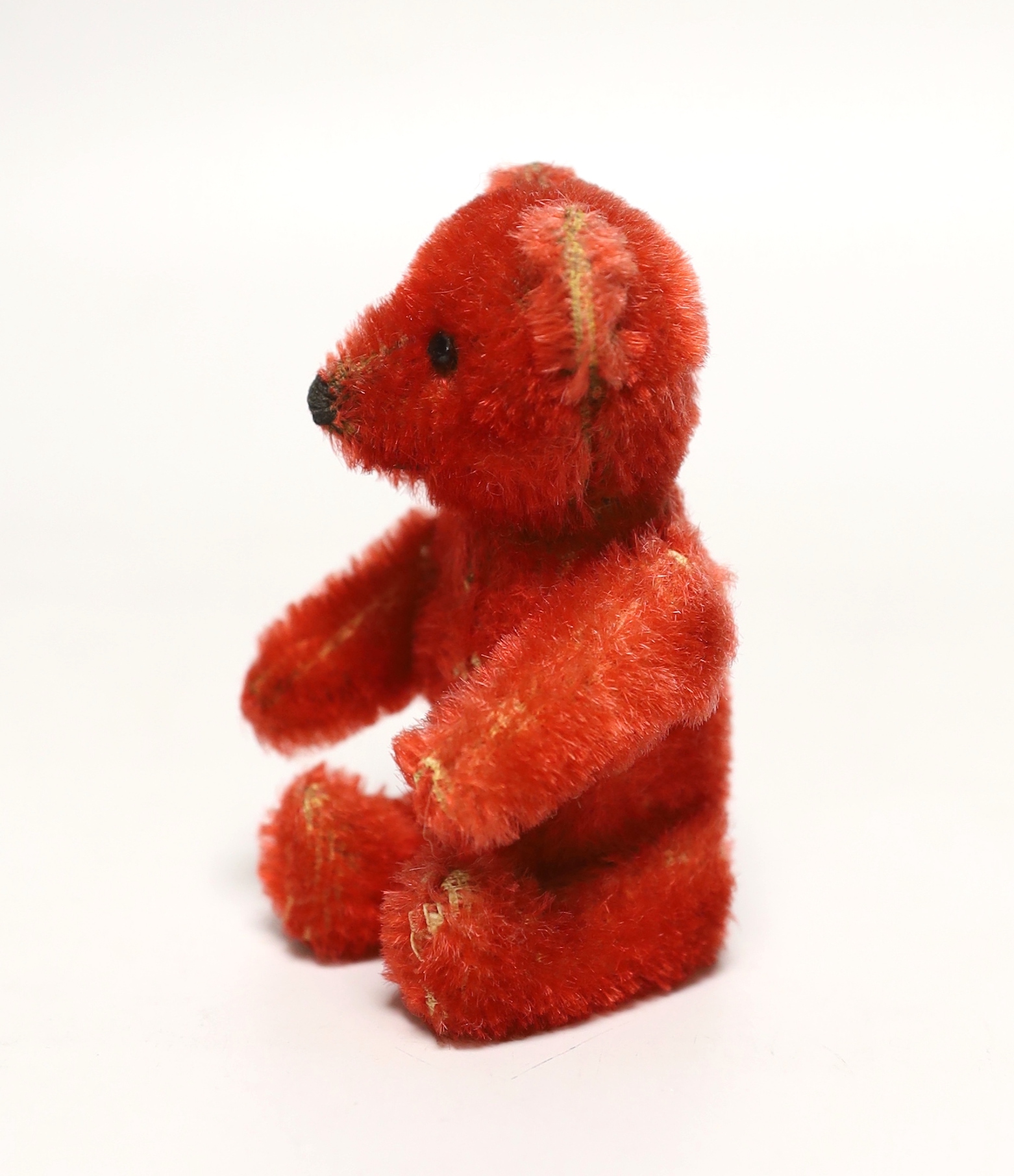 A red Schuco perfume bear, c.1920s, 5in., in excellent condition, missing stopper